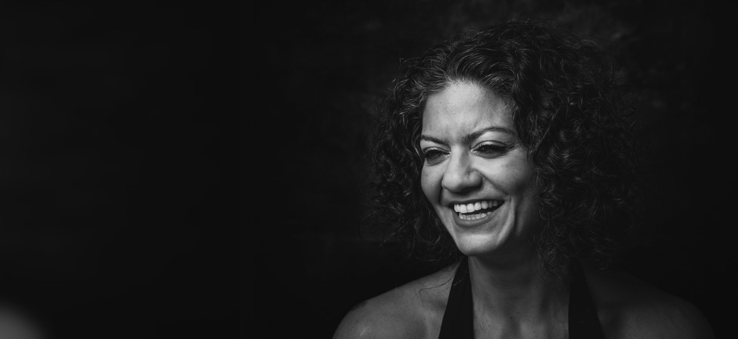 Rouba Zeidan laughing, black and white portrait